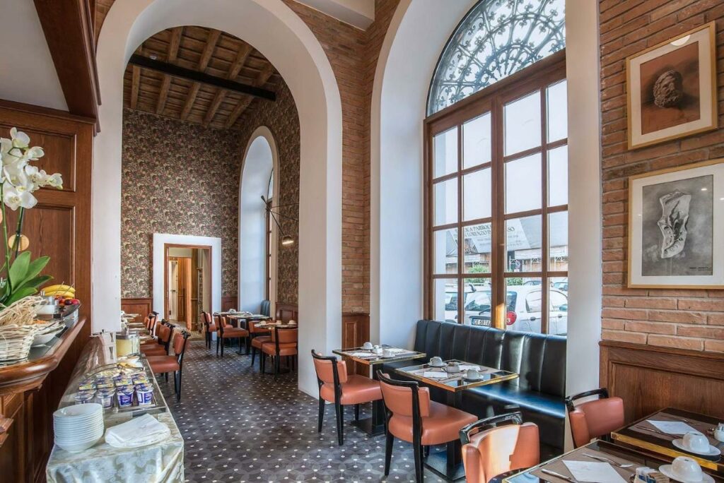 A spacious hotel restaurant with elegant arched windows