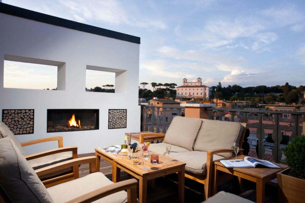 Stunning views from the rooftop terrace featuring a fireplace and seating area