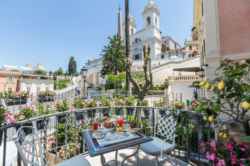 Balcony with table and chairs and lemon tree overlooking Spanish Steps.